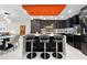 Bright modern kitchen with island seating, sleek dark cabinets and a view of the living and dining area at 101 S Gulfstream Ave. # 9C, Sarasota, FL 34236