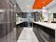 Sleek, modern kitchen with black cabinetry, stainless steel appliances, and white tile flooring at 101 S Gulfstream Ave. # 9C, Sarasota, FL 34236