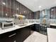Modern kitchen featuring sleek countertops, stainless steel appliances, and stylish backsplash at 101 S Gulfstream Ave. # 9C, Sarasota, FL 34236