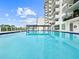 Bright outdoor pool with surrounding landscaping and a high-rise building in the background at 101 S Gulfstream Ave. # 9C, Sarasota, FL 34236