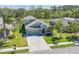 Overhead shot showcases a home with green lawn, adjacent to pond, and well-designed landscaping at 11037 77Th E St, Parrish, FL 34219