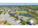 Aerial view of a residential neighborhood featuring homes, ponds, and green spaces under a clear sky at 11037 77Th E St, Parrish, FL 34219