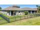 Aerial view of the backyard, patio, fenced yard, swing set, and pond at 11037 77Th E St, Parrish, FL 34219