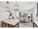 Bright and open dining room features a large dining table and seamlessly connects to the living room at 11037 77Th E St, Parrish, FL 34219