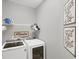 Well-organized laundry room with modern appliances and decorative wall art at 11037 77Th E St, Parrish, FL 34219
