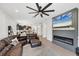 Open-concept living area featuring a sleek fireplace, comfortable seating, and views of the kitchen at 11037 77Th E St, Parrish, FL 34219