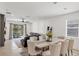 Living area with a comfortable seating area and a sliding glass door leading to the outdoor patio at 11037 77Th E St, Parrish, FL 34219