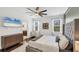 Comfortable primary bedroom with hardwood floors, natural light, and an ensuite bathroom at 11037 77Th E St, Parrish, FL 34219