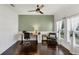 Bright home office space featuring a large window, sleek ceiling fan, and modern desk setup at 11037 77Th E St, Parrish, FL 34219