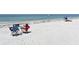 Chairs sit on the beach, inviting relaxation with the ocean waves in the background at 1110 93Rd Nw St, Bradenton, FL 34209