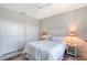 Bright bedroom features white furniture, soft bedding, a ceiling fan and two closets for ample storage at 1110 93Rd Nw St, Bradenton, FL 34209