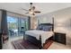 Serene main bedroom with a four-poster bed, outdoor access, and neutral decor for a relaxing retreat at 1110 93Rd Nw St, Bradenton, FL 34209