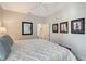 Comfortable bedroom with a well-made bed, neutral walls, and three lighthouse pictures at 1110 93Rd Nw St, Bradenton, FL 34209