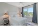 Inviting bedroom showcasing a plush bed, large windows offering scenic views, and stylish decor at 1110 93Rd Nw St, Bradenton, FL 34209