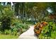 Lush botanical garden with a stone pathway winding through vibrant plants and flowers, showcasing natural beauty at 1110 93Rd Nw St, Bradenton, FL 34209