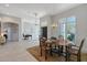Elegant dining room with a wooden table set for a meal, chandelier lighting, and views to the front yard at 1110 93Rd Nw St, Bradenton, FL 34209