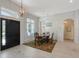 Dining room featuring a wooden table, chandelier, and views of the front entryway and adjacent spaces at 1110 93Rd Nw St, Bradenton, FL 34209