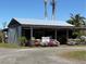 Geraldson's Gathering Farm featuring a rustic farm stand with colorful flowers and fresh produce for sale at 1110 93Rd Nw St, Bradenton, FL 34209