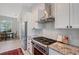 A kitchen with stainless steel appliances, granite countertops, and a stove with a stainless hood vent at 1110 93Rd Nw St, Bradenton, FL 34209