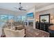 Open-concept living space with a fireplace, comfortable seating, and views of the pool at 1110 93Rd Nw St, Bradenton, FL 34209
