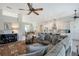 Open-concept living space features a large sectional sofa, view of the kitchen, dining area and elegant decor at 1110 93Rd Nw St, Bradenton, FL 34209