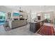 Open floor plan featuring a kitchen island, living room, and dining area with modern décor at 1110 93Rd Nw St, Bradenton, FL 34209