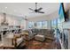Bright and airy living room with a large sectional sofa, fireplace, and expansive windows overlooking the outdoor space at 1110 93Rd Nw St, Bradenton, FL 34209