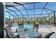 Alfresco dining on the lanai overlooking the pool and palm trees at 1110 93Rd Nw St, Bradenton, FL 34209