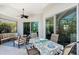 This covered patio includes a dining table with seating and a comfortable seating area for outdoor enjoyment at 1110 93Rd Nw St, Bradenton, FL 34209