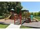 Community playground featuring slides, climbing structures, and ramps in a wooded area at 1110 93Rd Nw St, Bradenton, FL 34209