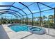 Stunning screened-in pool and spa with outdoor seating, lush plants and clear blue skies at 1110 93Rd Nw St, Bradenton, FL 34209