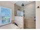 Walk-in shower featuring neutral tile, rainfall shower head, and a window providing natural light at 1110 93Rd Nw St, Bradenton, FL 34209