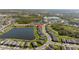Beautiful community view featuring a large lake surrounded by modern homes and lush landscaping at 11221 Gallatin Trl, Parrish, FL 34219