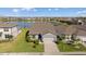 Gorgeous aerial view of house showcasing its well-manicured lawn, landscaping, and serene lake view at 11221 Gallatin Trl, Parrish, FL 34219
