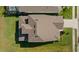 Aerial view showing a brown roof of a new house and a patch of green lawn at 11221 Gallatin Trl, Parrish, FL 34219