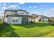 Expansive backyard featuring lush green grass and a covered patio, perfect for outdoor entertaining at 11221 Gallatin Trl, Parrish, FL 34219