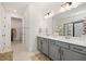 Bright bathroom featuring dual sinks, a walk-in shower, and a walk-in closet at 11221 Gallatin Trl, Parrish, FL 34219