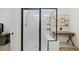 Beautiful bathroom features a black-framed glass shower and a vanity area with unique decor at 11221 Gallatin Trl, Parrish, FL 34219