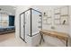 Beautiful bathroom features a black-framed glass shower, vanity area, and a view of the lake at 11221 Gallatin Trl, Parrish, FL 34219