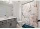 Bathroom with a vanity with gray cabinets and white marble countertop, toilet and shower with elegant marble design at 11221 Gallatin Trl, Parrish, FL 34219