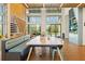 Inviting common area featuring a large table, bench seating, and contemporary design elements at 11221 Gallatin Trl, Parrish, FL 34219