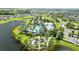 Scenic aerial view of the community pool area, featuring a playground, pool, and surrounding lakes at 11221 Gallatin Trl, Parrish, FL 34219