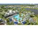 Breathtaking aerial shot of a community pool with lounge areas and beautifully manicured palm trees at 11221 Gallatin Trl, Parrish, FL 34219