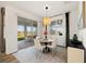 Bright dining area featuring a stylish light fixture and sliding glass doors for outdoor access at 11221 Gallatin Trl, Parrish, FL 34219