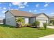 Attractive home with a landscaped front yard and a two-car garage, offering curb appeal at 11221 Gallatin Trl, Parrish, FL 34219