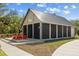 Exterior view of an activity center featuring orange Adirondack chairs on a wooden deck at 11221 Gallatin Trl, Parrish, FL 34219