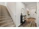 Inviting foyer with staircase, hardwood floors, and decorative furnishings at 11221 Gallatin Trl, Parrish, FL 34219