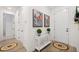 Stylish foyer with wooden floors, decorative console table, and art pieces on the wall at 11221 Gallatin Trl, Parrish, FL 34219