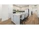 Modern kitchen with a large island, stylish chairs, and stainless steel appliances at 11221 Gallatin Trl, Parrish, FL 34219