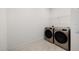 Bright laundry room featuring modern, stainless steel washer and dryer at 11221 Gallatin Trl, Parrish, FL 34219